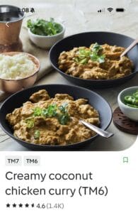 Creamy coconut chicken curry with rice and herbs