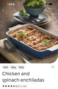 Baked chicken and spinach enchiladas in casserole dish